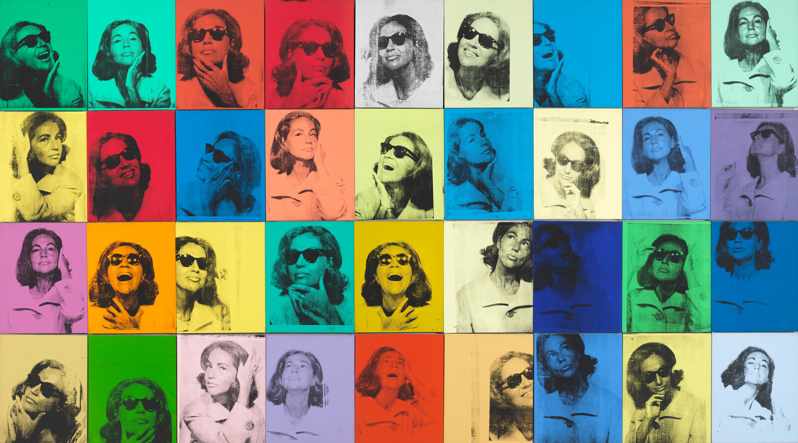 36 canvases in different bright colors with a black and white photo of a woman printed on each one.