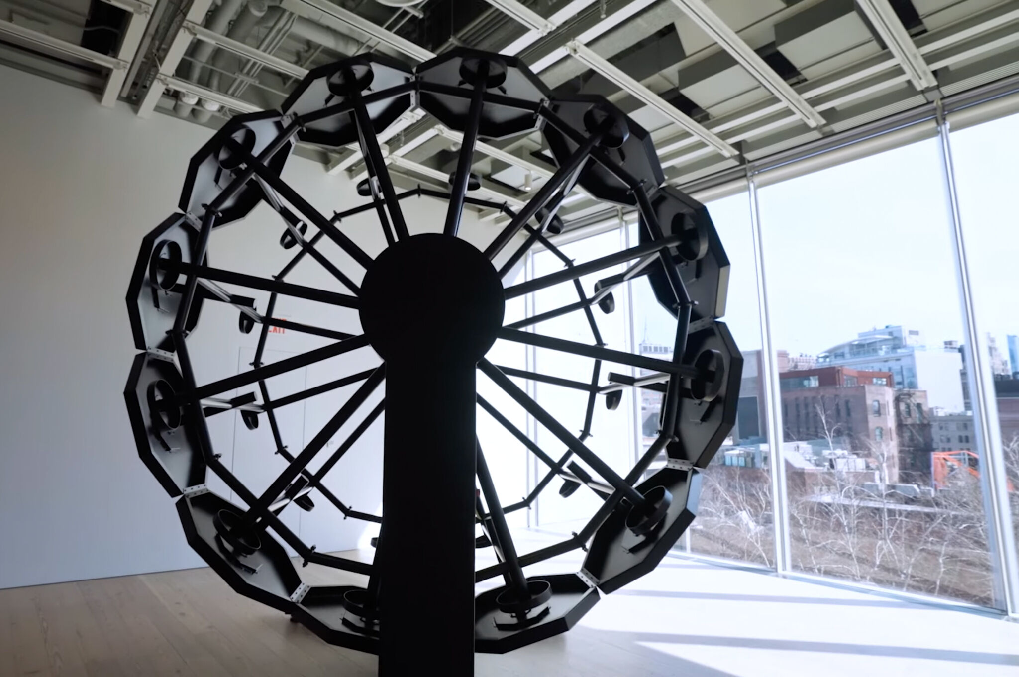 A black ferris wheel more than fourteen feet tall. 