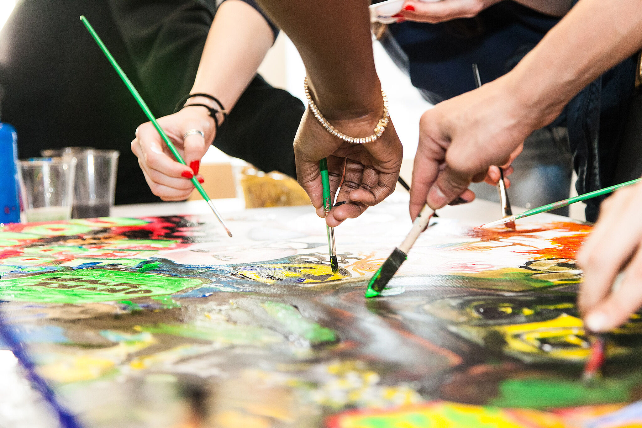 A group of teens paint together