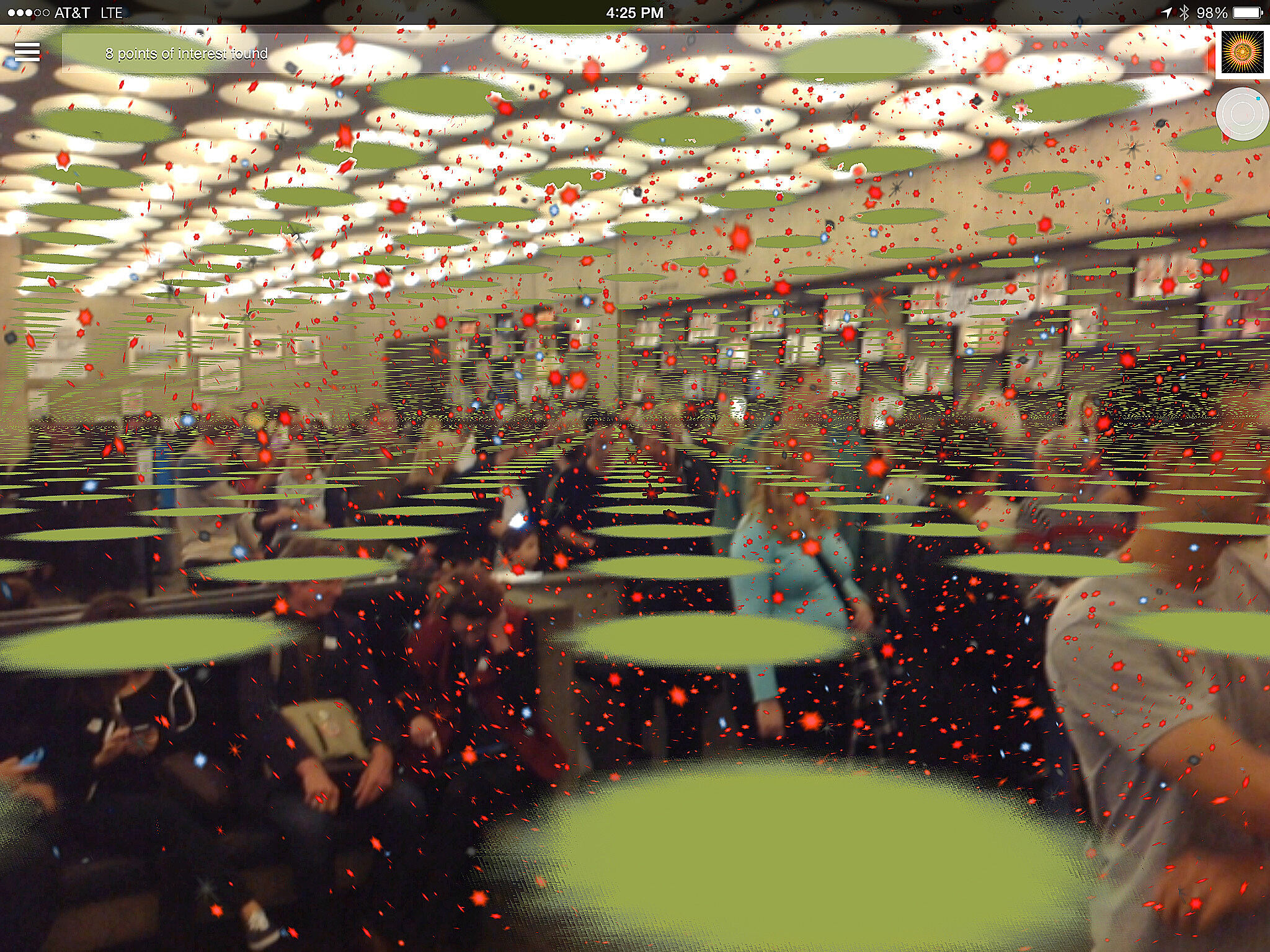 Image of a room in the museum with people sitting in chairs, covered by green circles receding into the distance and smaller red dots.