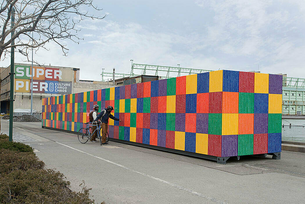 Colorful metal container with bikers examining.