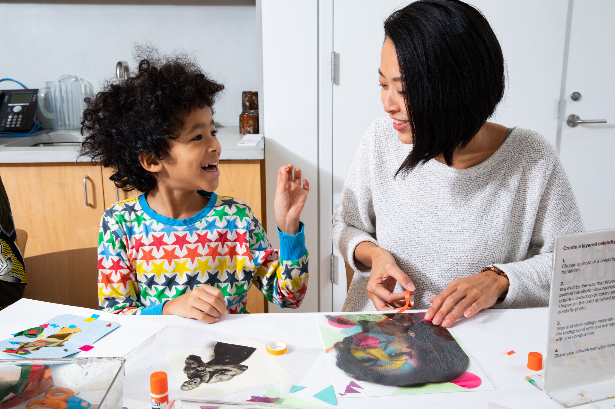 Mother and child making art in a bright studio.